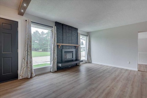 3 Armstrong Close, Red Deer, AB - Indoor Photo Showing Living Room With Fireplace