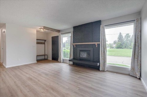 3 Armstrong Close, Red Deer, AB - Indoor Photo Showing Living Room With Fireplace