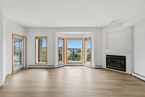 422-4512 52 Avenue, Red Deer, AB - Indoor Photo Showing Living Room With Fireplace