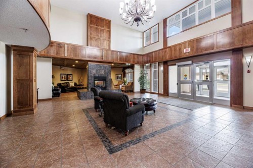 109-5213 61 Street, Red Deer, AB - Indoor Photo Showing Other Room With Fireplace