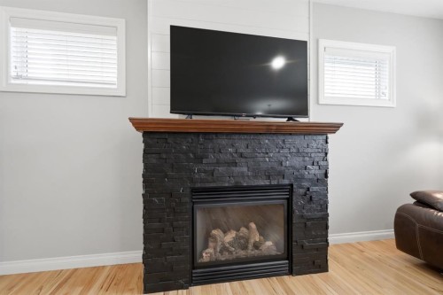 62 Traptow Close, Red Deer, AB - Indoor Photo Showing Living Room With Fireplace