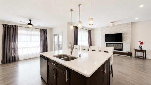 78 Cranarch View Se, Calgary, AB - Indoor Photo Showing Kitchen With Fireplace With Double Sink