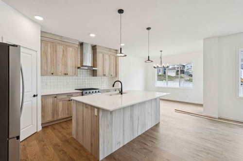 1030 Bayview Crescent Sw, Airdrie, AB - Indoor Photo Showing Kitchen With Upgraded Kitchen