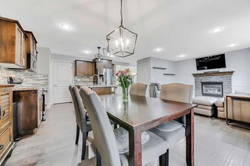 210 Viscount Drive, Red Deer, AB - Indoor Photo Showing Dining Room With Fireplace