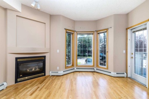 105-4512 52 Avenue, Red Deer, AB - Indoor Photo Showing Living Room With Fireplace