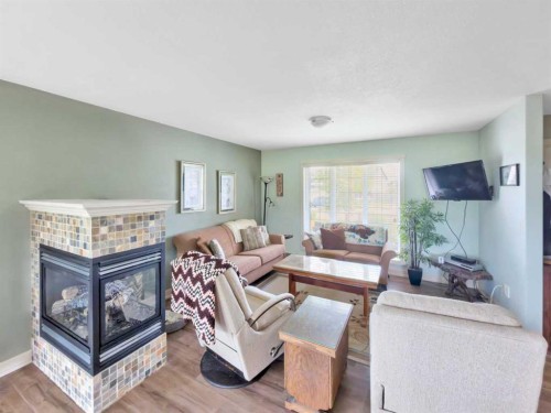 128 12 Ave Ne, Sundre, AB - Indoor Photo Showing Living Room With Fireplace