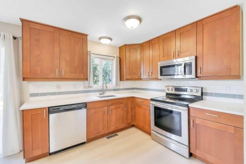 57 Newton Drive, Penhold, AB - Indoor Photo Showing Kitchen With Stainless Steel Kitchen