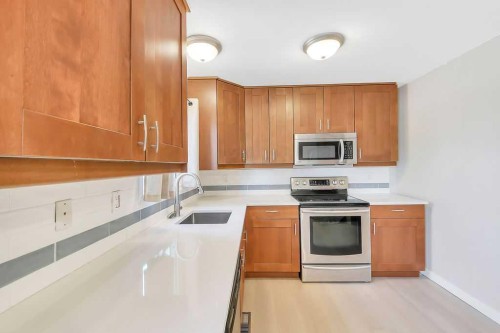 57 Newton Drive, Penhold, AB - Indoor Photo Showing Kitchen With Stainless Steel Kitchen
