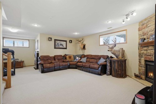 16 Filbert Close, Sylvan Lake, AB - Indoor Photo Showing Basement With Fireplace