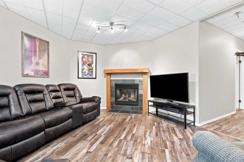 2 Pheasantback Close, Stettler, AB - Indoor Photo Showing Living Room With Fireplace