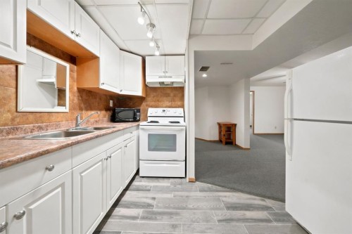 4233 33 Street, Red Deer, AB - Indoor Photo Showing Kitchen With Double Sink