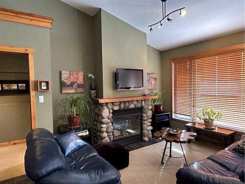 80 Ironstone, Blairmore, AB - Indoor Photo Showing Living Room With Fireplace