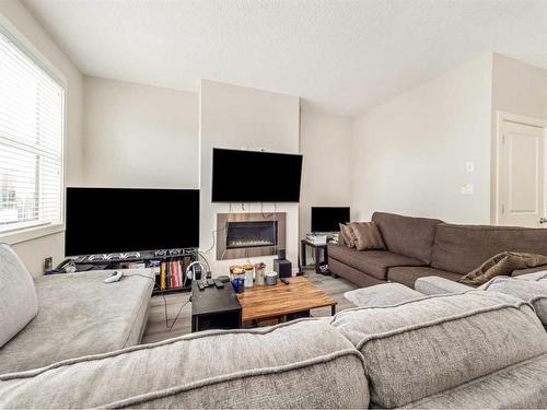 2-79 Aquitania Circle West, Lethbridge, AB - Indoor Photo Showing Living Room With Fireplace