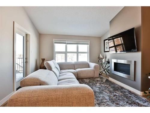 4-47 Aquitania Circle West, Lethbridge, AB - Indoor Photo Showing Living Room With Fireplace