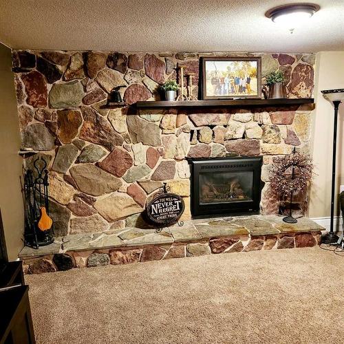 501 Highway, Cardston, AB - Indoor Photo Showing Living Room With Fireplace