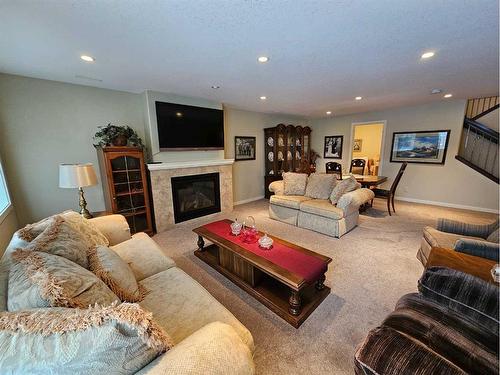 256 Blackwolf Way North, Lethbridge, AB - Indoor Photo Showing Living Room With Fireplace