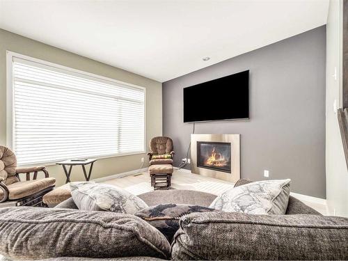 10 Haru Moriyama Road North, Lethbridge, AB - Indoor Photo Showing Living Room With Fireplace