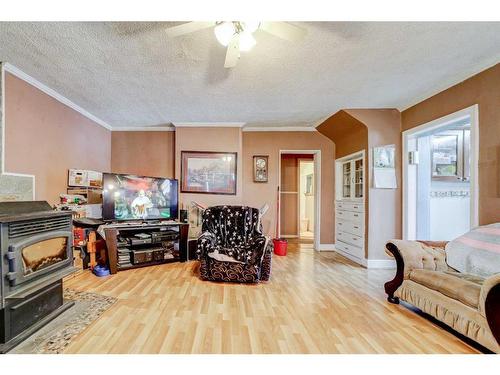 154 4Th Avenue East, Cardston, AB - Indoor Photo Showing Other Room With Fireplace