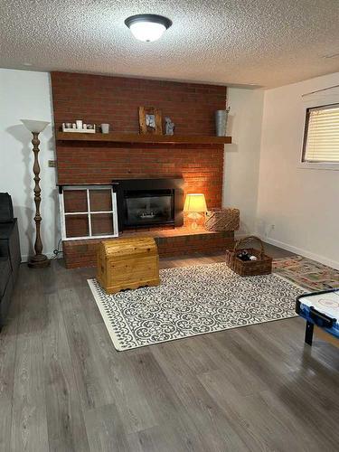 4513 Harvest Green, Taber, AB - Indoor Photo Showing Living Room With Fireplace