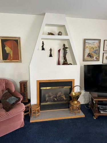 521 52 Avenue, Coalhurst, AB - Indoor Photo Showing Living Room With Fireplace