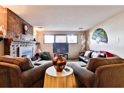 4013 22 Avenue South, Lethbridge, AB - Indoor Photo Showing Living Room With Fireplace
