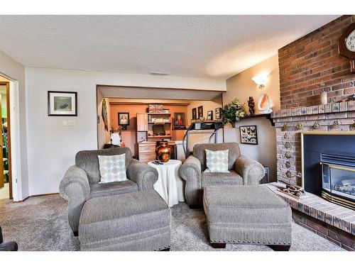 4013 22 Avenue South, Lethbridge, AB - Indoor Photo Showing Living Room With Fireplace