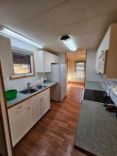 716 Main Street Ne, Milk River, AB - Indoor Photo Showing Kitchen With Double Sink