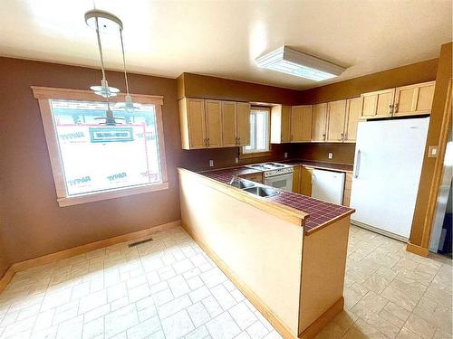 823 Alberta Avenue, Nobleford, AB - Indoor Photo Showing Kitchen With Double Sink