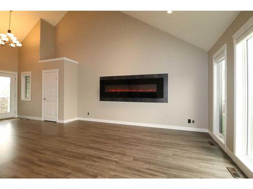 128 Gateway Mews South, Lethbridge, AB - Indoor Photo Showing Living Room With Fireplace