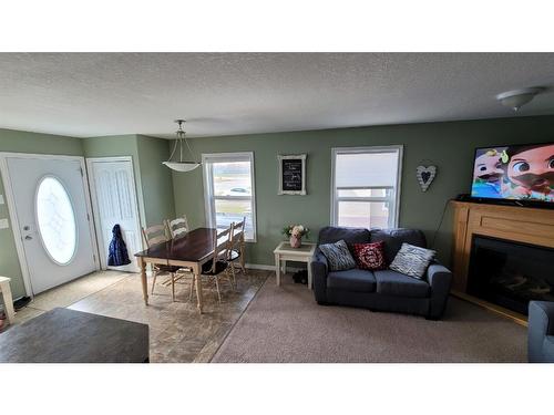 359 3 Avenue West, Cardston, AB - Indoor Photo Showing Living Room With Fireplace