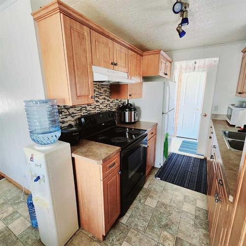 5303 54 Street, Taber, AB - Indoor Photo Showing Kitchen With Double Sink
