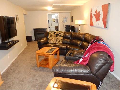 709 7 Street North, Lethbridge, AB - Indoor Photo Showing Living Room With Fireplace