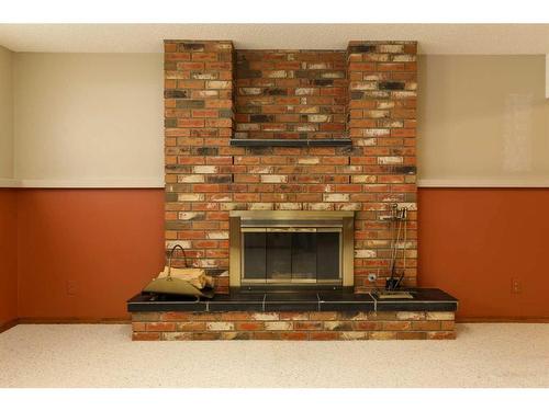 14 Quail Place North, Lethbridge, AB - Indoor Photo Showing Living Room With Fireplace