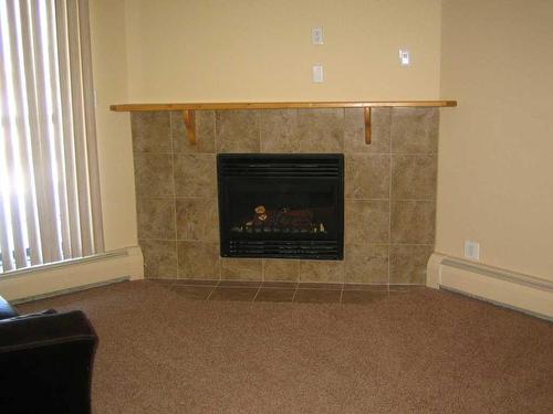 307-4210 20 Avenue South, Lethbridge, AB - Indoor Photo Showing Living Room With Fireplace