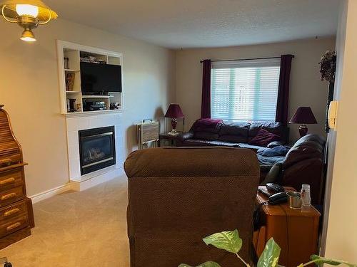 422 West Creek Drive, Cardston, AB - Indoor Photo Showing Living Room With Fireplace
