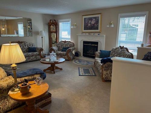 422 West Creek Drive, Cardston, AB - Indoor Photo Showing Living Room With Fireplace