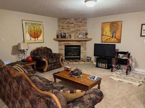 422 West Creek Drive, Cardston, AB - Indoor Photo Showing Living Room With Fireplace