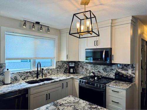 2 Chinook Heights South, Lethbridge, AB - Indoor Photo Showing Kitchen With Double Sink