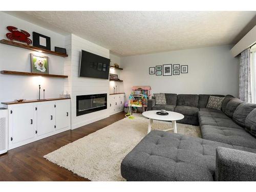 1022 14 Street North, Lethbridge, AB - Indoor Photo Showing Living Room With Fireplace