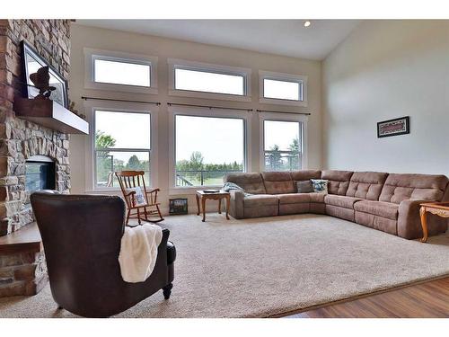 52 Cobblestone Lane, Raymond, AB - Indoor Photo Showing Living Room With Fireplace