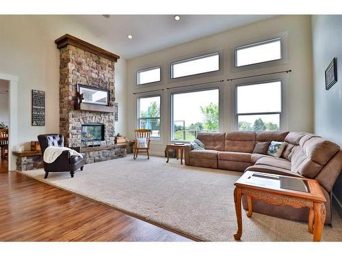 52 Cobblestone Lane, Raymond, AB - Indoor Photo Showing Living Room With Fireplace