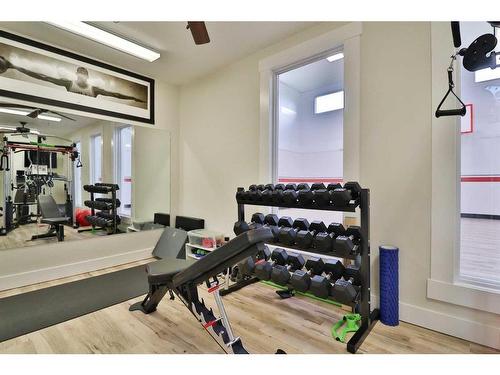 52 Cobblestone Lane, Raymond, AB - Indoor Photo Showing Gym Room