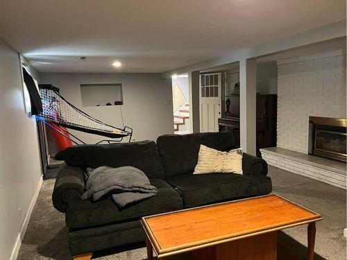 69E 1 Avenue South, Magrath, AB - Indoor Photo Showing Living Room With Fireplace