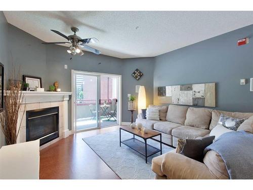 301-777 3 Avenue Sw, Calgary, AB - Indoor Photo Showing Living Room With Fireplace