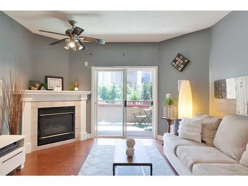 301-777 3 Avenue Sw, Calgary, AB - Indoor Photo Showing Living Room With Fireplace