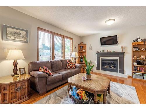 302 Sherwood Place West, Lethbridge, AB - Indoor Photo Showing Living Room With Fireplace