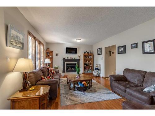 302 Sherwood Place West, Lethbridge, AB - Indoor Photo Showing Living Room With Fireplace