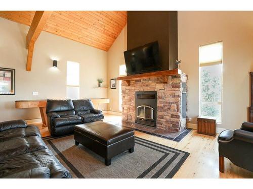 459 Sunset Drive, Rural Vulcan County, AB - Indoor Photo Showing Living Room With Fireplace