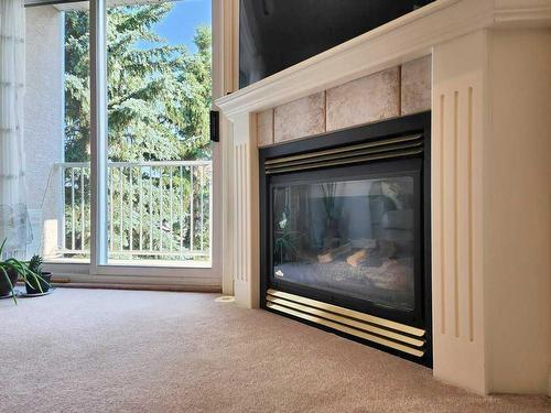 202-6 Skyline, Claresholm, AB - Indoor Photo Showing Living Room With Fireplace