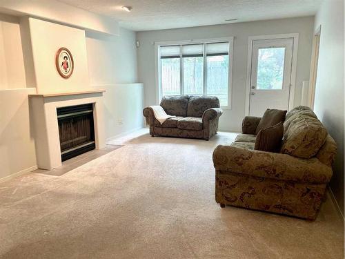 17 Bluefox Place North, Lethbridge, AB - Indoor Photo Showing Living Room With Fireplace